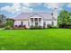 Spacious backyard featuring a lush green lawn, well-maintained landscaping, and a charming covered back porch at 13145 Roma Bnd, Carmel, IN 46074