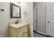Neutral bathroom features a single sink vanity with a granite countertop and a framed mirror at 13145 Roma Bnd, Carmel, IN 46074