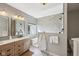 Spa-like bathroom featuring a glass shower, soaking tub, and modern vanity at 13145 Roma Bnd, Carmel, IN 46074