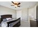 Comfortable carpeted bedroom with a ceiling fan, neutral walls, and a closet for storage at 13145 Roma Bnd, Carmel, IN 46074