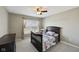 Cozy bedroom featuring carpet flooring, a ceiling fan, and a window with blinds at 13145 Roma Bnd, Carmel, IN 46074