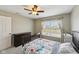 Cozy bedroom features carpet flooring, a ceiling fan, and a window with blinds at 13145 Roma Bnd, Carmel, IN 46074