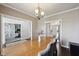 Dining room with wooden table, stylish chairs, and views into adjacent rooms, enhancing the open feel at 13145 Roma Bnd, Carmel, IN 46074