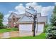 Lovely brick home featuring a three-car garage, a basketball hoop, and a well-manicured front lawn at 13145 Roma Bnd, Carmel, IN 46074