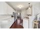 Kitchen features include white cabinets, stainless steel appliances, and hardwood floors at 13145 Roma Bnd, Carmel, IN 46074