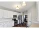 Bright eat-in kitchen with stainless steel appliances, white cabinetry and hardwood floors at 13145 Roma Bnd, Carmel, IN 46074