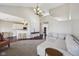 Open-concept living room with hardwood floors, a large sectional sofa, and seamless flow to the kitchen at 13145 Roma Bnd, Carmel, IN 46074