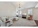 Bright living room with fireplace, large sectional, high ceilings, and ample natural light at 13145 Roma Bnd, Carmel, IN 46074