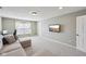Spacious living room with plush seating, a large window, and a mounted TV at 13145 Roma Bnd, Carmel, IN 46074