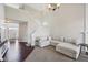 Light-filled living room with a large sectional sofa, wooden floors, and an adjacent staircase at 13145 Roma Bnd, Carmel, IN 46074