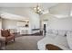 Spacious open concept living room with wood flooring, leading to the kitchen and an adjacent staircase at 13145 Roma Bnd, Carmel, IN 46074