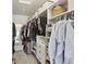 A walk-in closet offering ample storage space with custom shelving, drawers, and hanging rods at 13145 Roma Bnd, Carmel, IN 46074