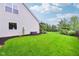 Side view of large backyard with plenty of room, established landscaping, and a well-manicured lawn at 13145 Roma Bnd, Carmel, IN 46074