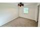 Bedroom featuring neutral carpet, white walls, and modern light fixture at 1328 N 300 E, Anderson, IN 46012