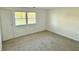 Bedroom featuring neutral carpet, white walls, and window views at 1328 N 300 E, Anderson, IN 46012