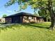 Beautiful brick home with attached garage and a well-maintained lawn and mature tree shading the yard at 1328 N 300 E, Anderson, IN 46012