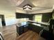 Modern kitchen featuring stylish cabinetry, countertops, stainless steel appliances, and hardwood floors at 1328 N 300 E, Anderson, IN 46012