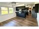 Modern kitchen with dark cabinetry, stainless steel appliances, breakfast bar and hardwood style flooring at 1328 N 300 E, Anderson, IN 46012