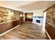 Cozy living room features wood accent walls, an inviting fireplace, and durable floors at 1328 N 300 E, Anderson, IN 46012