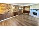 Cozy living room features wood accent walls, an inviting fireplace, and durable floors at 1328 N 300 E, Anderson, IN 46012