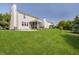 Spacious backyard with a manicured lawn, patio, and a screened-in porch for outdoor enjoyment at 14135 Nicholas Dr, Carmel, IN 46074