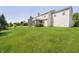 Expansive backyard featuring a large lawn and a screened-in porch perfect for outdoor relaxation at 14135 Nicholas Dr, Carmel, IN 46074