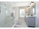 Bright bathroom featuring a glass-enclosed shower, soaking tub, and double vanity with modern fixtures at 14135 Nicholas Dr, Carmel, IN 46074