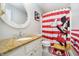 Bright bathroom featuring Mickey Mouse shower curtain, granite countertop and modern sink at 14135 Nicholas Dr, Carmel, IN 46074