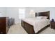 Cozy bedroom featuring a wooden bed frame, carpet flooring, and neutral-colored walls and bedding at 14135 Nicholas Dr, Carmel, IN 46074