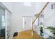 Bright foyer with hardwood floors, a staircase, and decorative details at 14135 Nicholas Dr, Carmel, IN 46074