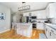 Updated kitchen with stainless steel appliances, granite countertops, white cabinetry, and breakfast bar seating at 14135 Nicholas Dr, Carmel, IN 46074