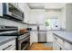 Close-up of kitchen with stainless steel appliances, granite countertops, subway tile backsplash, and modern fixtures at 14135 Nicholas Dr, Carmel, IN 46074