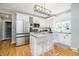 Stylish kitchen features stainless steel appliances, granite countertops, white cabinets, and modern lighting at 14135 Nicholas Dr, Carmel, IN 46074