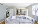 Open-concept living room flows into kitchen, featuring a comfortable sofa, hardwood floors, and neutral decor at 14135 Nicholas Dr, Carmel, IN 46074