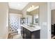 Elegant bathroom with a double vanity, a large mirror, and an elephant-themed shower curtain at 15116 Fenchurch Dr, Westfield, IN 46074