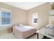 Comfortable bedroom with neutral tones, two windows and a pink duvet at 15116 Fenchurch Dr, Westfield, IN 46074