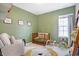Cozy Bedroom with olive-colored walls, wood crib, rocker, and a playful lion rug at 15116 Fenchurch Dr, Westfield, IN 46074