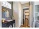 Charming entryway featuring a dark accent wall, modern console table, and convenient coat hooks near the doorway at 15116 Fenchurch Dr, Westfield, IN 46074
