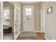 Inviting entryway with a white front door and sidelights, beautiful flooring, and French doors to the left at 15116 Fenchurch Dr, Westfield, IN 46074