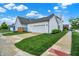 Exterior view of home highlighting the lawn, driveway, and the attached two-car garage at 15116 Fenchurch Dr, Westfield, IN 46074
