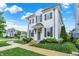 An exterior elevation showing a white brick home, beautiful yard, and a lovely curved sidewalk at 15116 Fenchurch Dr, Westfield, IN 46074