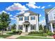 Charming two-story home with a white painted brick exterior, a beautiful yard, and meticulous landscaping at 15116 Fenchurch Dr, Westfield, IN 46074