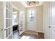 Inviting foyer with hardwood floors and natural light from glass paneled door at 15116 Fenchurch Dr, Westfield, IN 46074