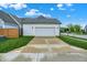 Exterior view of the home's attached two-car garage and driveway at 15116 Fenchurch Dr, Westfield, IN 46074