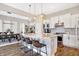 Bright kitchen boasts an island with granite countertops and seating, stainless appliances, and seamlessly connects to the dining area at 15116 Fenchurch Dr, Westfield, IN 46074