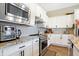 Bright kitchen showcasing stainless steel appliances, modern backsplash, sleek white cabinetry, and granite countertops at 15116 Fenchurch Dr, Westfield, IN 46074