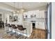 Modern kitchen with seating at the kitchen island, white cabinets, and stainless steel appliances at 15116 Fenchurch Dr, Westfield, IN 46074