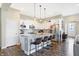 Modern kitchen features stainless steel appliances, granite countertops, white cabinets, and an island with barstool seating at 15116 Fenchurch Dr, Westfield, IN 46074