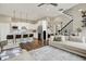 Open-concept living area showcasing a well-equipped kitchen, comfortable seating, and a modern staircase at 15116 Fenchurch Dr, Westfield, IN 46074