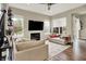 Cozy living room with a modern fireplace, large windows, and comfortable couches creating a relaxing atmosphere at 15116 Fenchurch Dr, Westfield, IN 46074